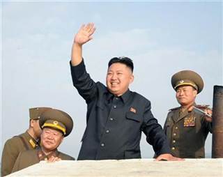 North Korean leader Kim Jong-Un waves as he visits military units on islands in the most southwest of Pyongyang