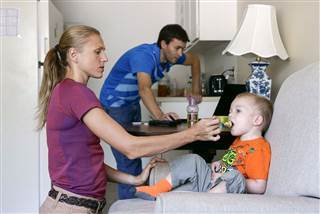 Image: Russian Olympian couple Yuliya and Vitaly Stepanovs with their son after an interview with Reuters