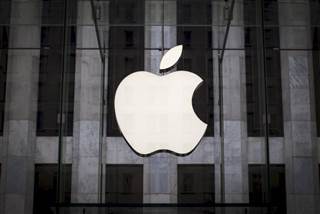 Image: File photo of an Apple logo hanging above the entrance to the Apple store on 5th Avenue in the Manhattan borough of New York City