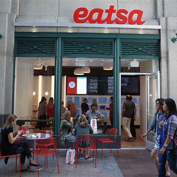 Image: People walk by eatsa, a fully automated fast food restaurant