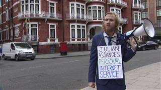 Image: A comedian reads the Internet to Julian Assange outside Ecuador's embassy in London