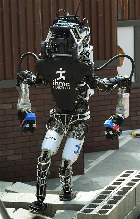 The robot named 'Running Man' developed by Team IHMC Robotics walks an obstacle course during the finals of the DARPA Robotics Challenge at the Fairplex complex in Pomona, Calif. on June 5, 2015. (Photo by Mark Ralston/AFP/Getty)