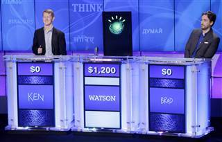 "Jeopardy!" champions Ken Jennings, left, and Brad Rutter, right, flank a prop representing Watson during a practice round of the "Jeopardy!" quiz show in Yorktown Heights, N.Y. on Jan. 13, 2011. (Photo by Seth Wenig/AP)