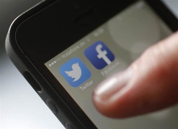 An illustration picture shows a man starting his Twitter App on a mobile device in Hanau near Frankfurt