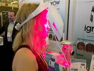 Image: NBC News technology reporter Alyssa Newcomb tries on the iDerma from Apira Science.