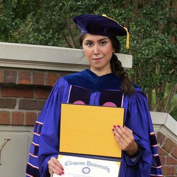 Image: Nazanin Zinouri poses for a photo with her PhD degree from Clemson University in Clemson, South Carolina.