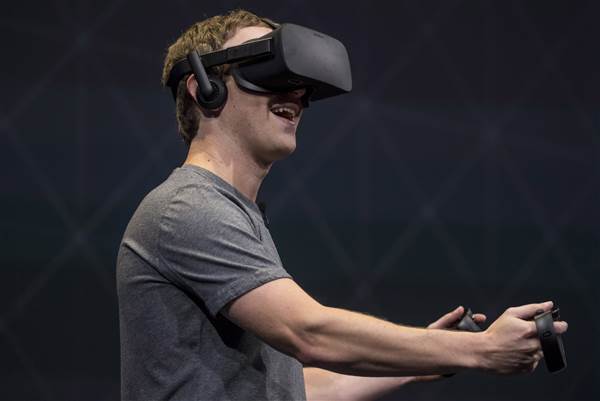 Image: Facebook founder and CEO,Mark Zuckerberg, demonstrates an Oculus Rift virtual reality (VR) headset and Oculus Touch controllers as the gives a demonstration during the Oculus Connect 3 event in San Jose, Calif., on Oct. 6, 2016.