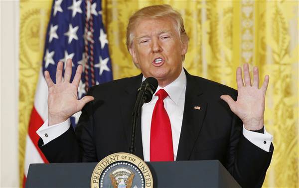 Image: Trump reacts during news conference at the White House in Washington