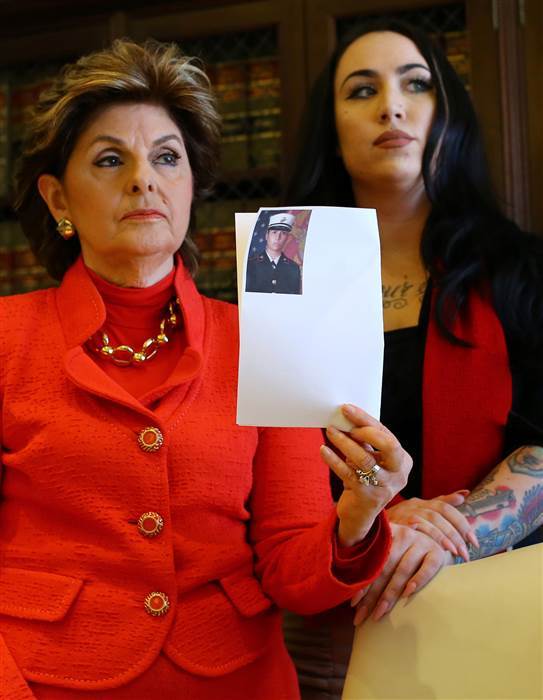 Image: Attorney Gloria Allred holds photograph with Erika Butner