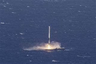 Image: Handout photo of the reusable main-stage booster from the SpaceX Falcon 9 makes a successful landing on a platform in the Atlantic Ocean about 185 Nautical miles off the coast of Florida