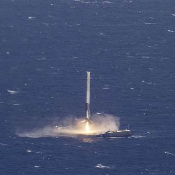 Image: Handout photo of the reusable main-stage booster from the SpaceX Falcon 9 makes a successful landing on a platform in the Atlantic Ocean about 185 Nautical miles off the coast of Florida