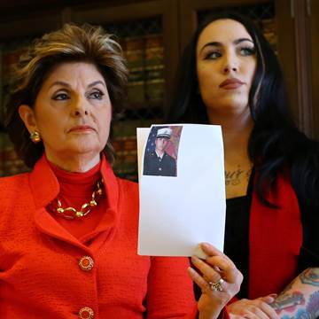 Image: Attorney Gloria Allred holds photograph with Erika Butner