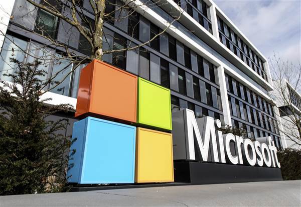 Image: The Microsoft logo on the facade of a Microsoft Center.