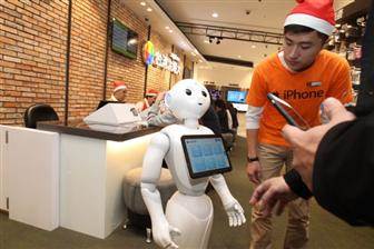 Pepper, a service-oriented robot developed by Japan-based SoftBank, serves customers at a mobile telecom retail store.
