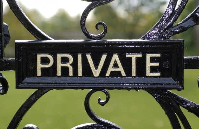 shutterstock 64776670 Private sign on vintage black iron gate with foresty estate in the background