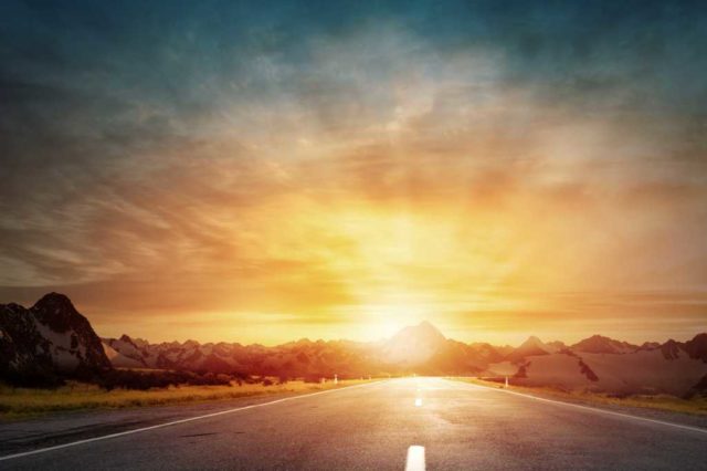 shutterstock 293703398 driving into the sunset sunrise dawn dusk road