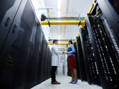 AI Strategies Under Siege: Inefficient Archiving Solutions S… IT professionals shaking hands on a server room hallway.