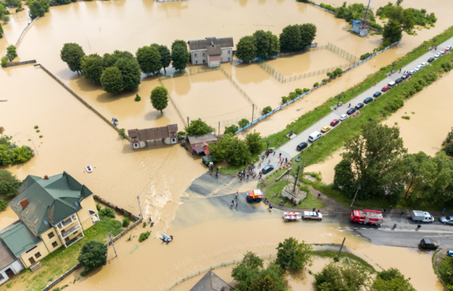 Aerial view of a flooded area and rescue vehicles.