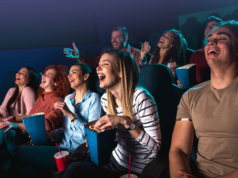 IMAX Expands Global Reach With Camb.AI’s AI Speech Translati… Group of people laughing while watching a movie.