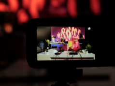 Lightricks’ LTXV Model Breaks Speed Records, Generating 5-Se… Influencer with pink hair showing a notebook to the camera while on stream.