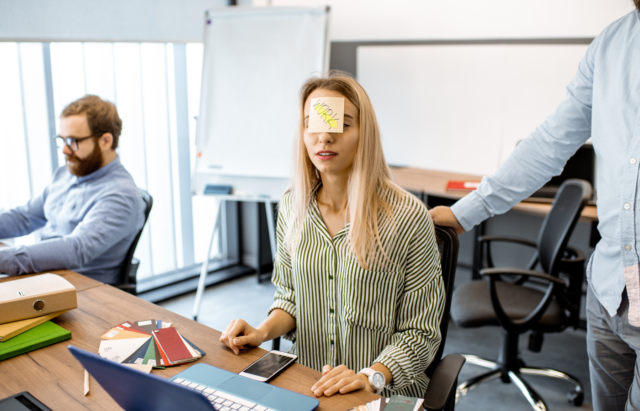 Tired woman with sticker on the head in the office.