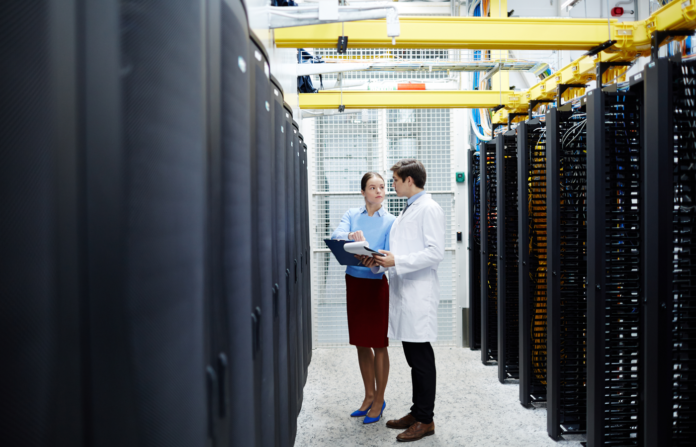 IT professionals on a data center hallway.