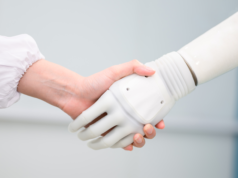 Accenture: 77% of Executives Say Autonomous AI Needs to be B… Woman shaking hands with a robot.