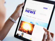 Apple Spars With News Outlets Over Fake AI-Generated Headlin… Woman reading news on a tablet.