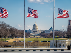 Trump Revokes Biden EO Addressing AI Risks: What It Means American flags with the US Capitol Building on the background.