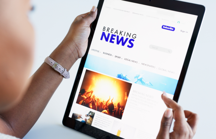 Woman reading news on a tablet.