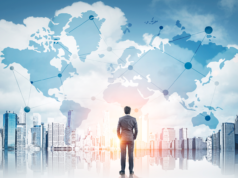 Paris AI Action Summit: Which Tech and Global Leaders Will A… Businessman looking towards an abstract background of the world map and city scape.