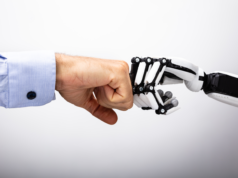 The Future of Recruiting: More AI and Human Connection Human and robot hand making a fist bump.