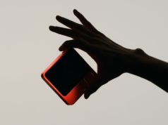 Rabbit’s New Android AI Agent Shows Promise But Remains a Wo… Semi silhouette of a hand holding a device.