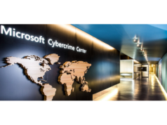 Microsoft Cracks Down on Global Cybercrime Network Exploitin… A hallway with Microsoft Cybercrime Center sign on the wall.