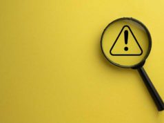 Linux Foundation warns of US OFAC sanctions Attention, warning sign; exclamation mark under a magnifying glass.