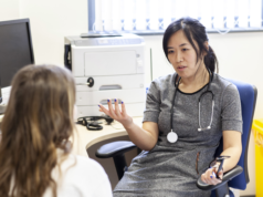 Microsoft’s New Dragon AI Copilot Fights Healthcare Paperwor… Doctor discussing with patient in a medical office.