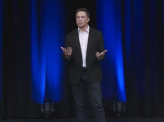 NAACP Demands Shutdown of Elon Musk’s xAI ‘Dirty Data Center… A photo of Elon Musk speaking on a stage.