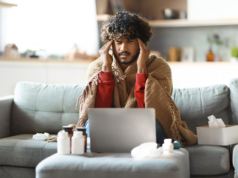 Ever Consult ‘Dr. Google’? Expect More Search Results for Me… Sick man covered in blanket and sitting on a couch at home.