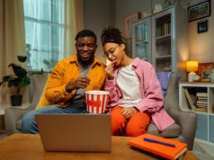 Not Sure What to Watch Next? Just Ask Netflix’s New Conversa… Stock photo of two young adults watching a movie.