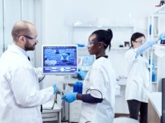 AI Surpasses Virologists in Lab Tasks, Sparking Bioweapon Sa… African assitant discussing wtih scientist about virus experiment in chemistry laboratory.