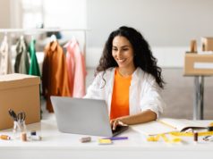 PayPal Just Made It Easier to Shop While Using This AI Chatb… A woman shopping clothes online using her laptop.