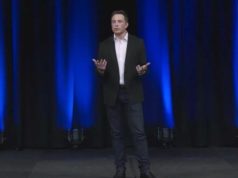 Elon Musk Returns to 24/7 Grind & Prioritizes X, xAI, Tesla,… Elon Musk presenting on stage.