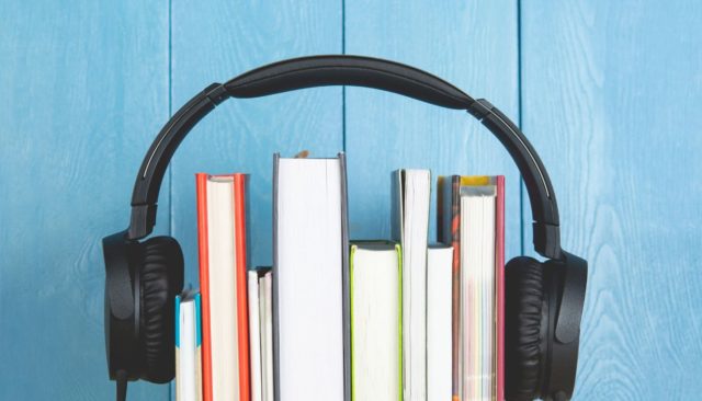 headphone and books on blue background.