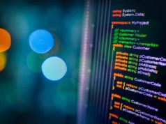 C# 14 introduces extension members C# programming language C sharp source code example on monitor and bokeh background.