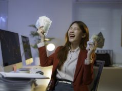 Want a Raise? Use and Maintain Your AI Skills Stock photo of a businesswoman celebrating with cash in her hands.
