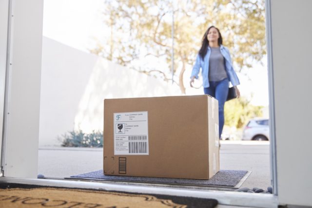 1749352842_Amazon-Tests-Humanoid-Delivery-Bots-Says-Robots-Will-Soon.jpeg Stock photo of a woman coming home to a delivered package.