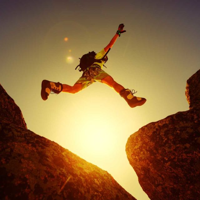 Spring-Java-creator-unveils-AI-agent-framework-for-the.jpg Leap, jump, risk, adventure. A person leaping between two boulders.