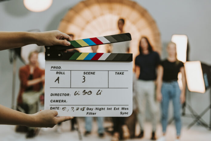 Woman holding a movie production clapperboard