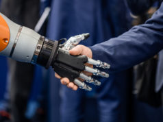 Ilya Sutskever Named CEO of Superintelligence Startup After … Hand of a businessman shaking hands with a Android robot.
