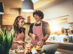 Best AI Tools to Make You a Better Cook A couple cooking in the kitchent,